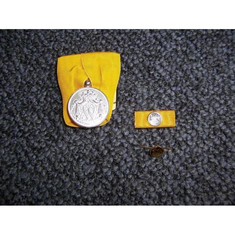 zilveren medaille en bijbehorende baton